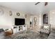 Comfortable living room features tile floors, neutral paint, a ceiling fan, and cozy furniture at 11133 E Dragoon Ave, Mesa, AZ 85208