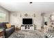 Comfortable living room features tile floors, neutral paint, a ceiling fan, and cozy furniture at 11133 E Dragoon Ave, Mesa, AZ 85208