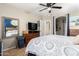 Bedroom with blue accent wall, ceiling fan, wooden headboard, and tiled floors at 11133 E Dragoon Ave, Mesa, AZ 85208