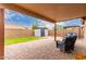 Spacious covered patio with brick flooring, seating, and a view of the backyard at 11133 E Dragoon Ave, Mesa, AZ 85208