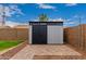 Modern storage shed with neutral colors and brick perimeter at 11133 E Dragoon Ave, Mesa, AZ 85208