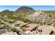 Stunning aerial view of homes nestled amongst scenic mountains and desert landscapes in a gated community at 11856 E Parkview Ln, Scottsdale, AZ 85255