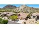 Beautiful aerial view of a home with a desert landscape, three car garage, and mountain views at 11856 E Parkview Ln, Scottsdale, AZ 85255