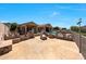 Expansive backyard featuring a custom outdoor kitchen, pool, and fire pit at 11856 E Parkview Ln, Scottsdale, AZ 85255