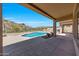 Covered patio overlooking a sparkling pool and beautiful mountain views at 11856 E Parkview Ln, Scottsdale, AZ 85255