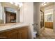 Well-lit bathroom featuring wood vanity with marble countertops and glass enclosed shower at 11856 E Parkview Ln, Scottsdale, AZ 85255