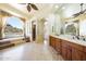 Inviting bathroom with dual sinks, a luxurious soaking tub and picturesque mountain views at 11856 E Parkview Ln, Scottsdale, AZ 85255