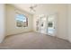 Bright bedroom with ceiling fan, large windows, and sliding glass doors to the outside at 11856 E Parkview Ln, Scottsdale, AZ 85255