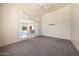 Bright and airy bedroom with neutral carpet, ceiling fan, and sliding glass doors at 11856 E Parkview Ln, Scottsdale, AZ 85255