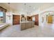 Spacious kitchen featuring custom cabinets, granite countertops, and a large center island with travertine floors at 11856 E Parkview Ln, Scottsdale, AZ 85255
