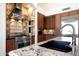 The luxury kitchen features granite counters, tile backsplash, and professional grade stainless steel appliances at 11856 E Parkview Ln, Scottsdale, AZ 85255