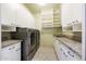 Modern laundry room includes stainless steel washer and dryer, granite countertops and extra storage at 11856 E Parkview Ln, Scottsdale, AZ 85255