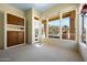 Bright living room featuring built-in shelving, large windows and views of the pool and backyard at 11856 E Parkview Ln, Scottsdale, AZ 85255