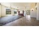 Large living room with built in wood cabinets, tile flooring, a chandelier, and multiple windows at 11856 E Parkview Ln, Scottsdale, AZ 85255
