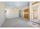 Open living room showcasing built in storage, neutral colors, and a view of an outside entryway at 11856 E Parkview Ln, Scottsdale, AZ 85255