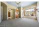 Spacious living room features carpet floors, built-in cabinets, and lots of natural light with access to the balcony at 11856 E Parkview Ln, Scottsdale, AZ 85255