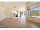 Living room with tile floors, a fireplace, and large windows with views of the pool and desert landscape at 11856 E Parkview Ln, Scottsdale, AZ 85255