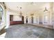 Open living room with arched entrances, wood cabinets, chandelier, and elegant tile flooring at 11856 E Parkview Ln, Scottsdale, AZ 85255
