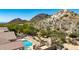 Tranquil backyard featuring a sparkling pool, spa, patio, and breathtaking mountain scenery at 11856 E Parkview Ln, Scottsdale, AZ 85255