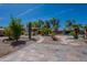 Backyard features a pool, desert landscaping, a seating area, and mature trees at 13305 W Colter St, Litchfield Park, AZ 85340