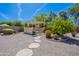 Serene backyard featuring a pergola, gravel, and stone walkways, creating a peaceful retreat at 13305 W Colter St, Litchfield Park, AZ 85340