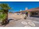 View of the backyard, complete with a stone seating area, desert landscaping, and outdoor grill at 13305 W Colter St, Litchfield Park, AZ 85340