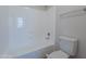 Clean bathroom featuring a tub and shower combination, white tile surround, and a modern toilet at 13305 W Colter St, Litchfield Park, AZ 85340