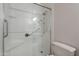 Walk-in shower featuring glass door, grab bar, and hand held shower head at 13305 W Colter St, Litchfield Park, AZ 85340