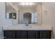 Bathroom vanity featuring quartz countertop, gray cabinets, and a large mirror at 13305 W Colter St, Litchfield Park, AZ 85340