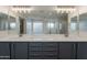 Modern bathroom with double sink vanity and marble countertops featuring modern light fixtures at 13305 W Colter St, Litchfield Park, AZ 85340