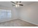 Bedroom with neutral walls, ceiling fan, carpet flooring, and bright window at 13305 W Colter St, Litchfield Park, AZ 85340
