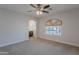 Bedroom with carpet flooring, ceiling fan, and arched window with natural light at 13305 W Colter St, Litchfield Park, AZ 85340