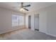 Bedroom features a ceiling fan, closet with sliding doors, and window at 13305 W Colter St, Litchfield Park, AZ 85340