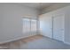 Bright bedroom featuring a window, ceiling fan, and sliding door closet at 13305 W Colter St, Litchfield Park, AZ 85340