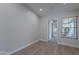 Bright bedroom featuring wood-look floors, natural light, and an open doorway to the rest of the home at 13305 W Colter St, Litchfield Park, AZ 85340