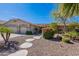 Beautiful single-story home with mature landscaping, a well-manicured yard, and a desert rock front yard at 13305 W Colter St, Litchfield Park, AZ 85340