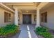Covered front porch with stately columns leading to an impressive entryway with elegant double doors at 13305 W Colter St, Litchfield Park, AZ 85340