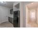 Charming kitchen featuring gray cabinets, a refrigerator, and modern countertops at 13305 W Colter St, Litchfield Park, AZ 85340