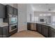 Modern kitchen featuring stainless steel appliances, sleek cabinetry, and open layout with sightlines to the living space at 13305 W Colter St, Litchfield Park, AZ 85340
