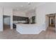 Bright, modern kitchen featuring an island with seating, gray cabinets, stainless appliances, and open floor plan at 13305 W Colter St, Litchfield Park, AZ 85340