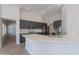 Open-concept kitchen with gray cabinetry, stainless steel appliances, quartz countertops, and a central island at 13305 W Colter St, Litchfield Park, AZ 85340