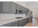 Well-appointed kitchen with stainless steel appliances, gray cabinets, and quartz countertops, adjacent to dining area at 13305 W Colter St, Litchfield Park, AZ 85340