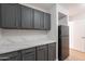 Kitchenette featuring gray cabinets, black refrigerator, and white countertop at 13305 W Colter St, Litchfield Park, AZ 85340