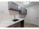 Laundry room featuring gray cabinets, a sink, and laundry hookups at 13305 W Colter St, Litchfield Park, AZ 85340