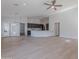 Spacious living room and kitchen combination with sleek appliances and modern finishes and luxury vinyl flooring at 13305 W Colter St, Litchfield Park, AZ 85340