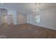 Open concept living room with light floors and modern chandelier at 13305 W Colter St, Litchfield Park, AZ 85340