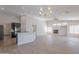 Open-concept living area featuring a fireplace, modern lighting, and luxury vinyl flooring at 13305 W Colter St, Litchfield Park, AZ 85340