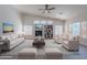 Inviting living room with a fireplace, built-in bookshelves, and ample natural light from multiple windows at 13305 W Colter St, Litchfield Park, AZ 85340