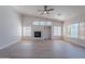 Bright and open living room showcasing a fireplace and large windows at 13305 W Colter St, Litchfield Park, AZ 85340