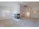 Cozy living room featuring a fireplace, ceiling fan, and natural light at 13305 W Colter St, Litchfield Park, AZ 85340